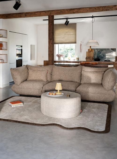 Compact indoor designer rug with rounded corners, a wavy edge, and a calm cream and brown colour palette.