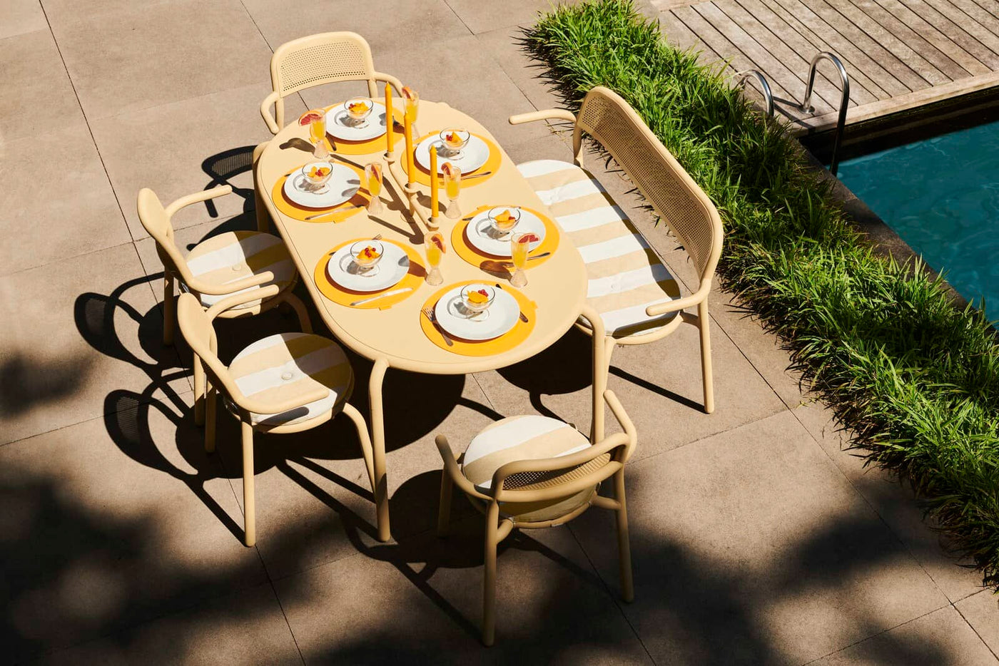 Fatboy Toní outdoor dining tables: Durable, lightweight aluminum with protective coating, spacious design, rounded corners, and adjustable feet.