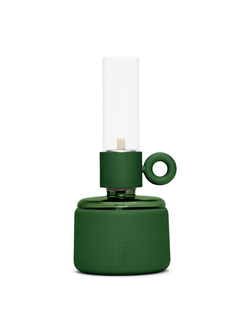 Flamtastique XS oil lamp in Deep Green with matte silicone finish, modern table lamp made of borosilicate glass for indoor and outdoor ambiance.