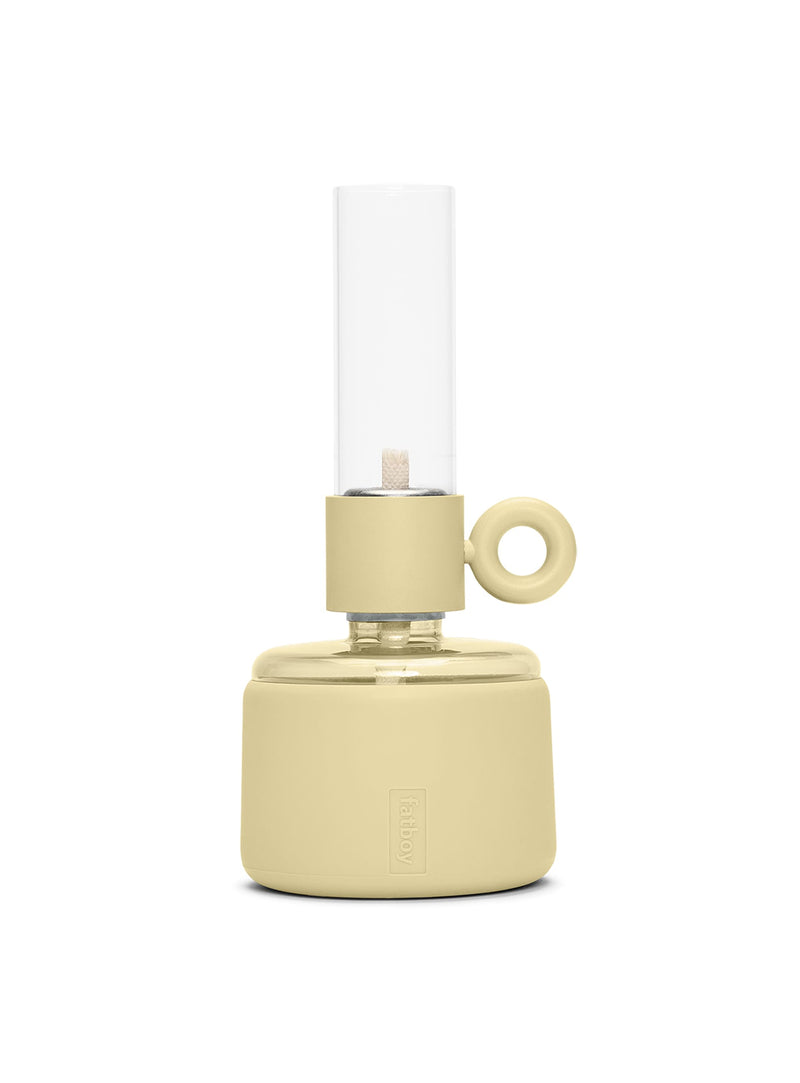 Flamtastique XS oil lamp in Pale Yellow with matte silicone finish, modern table lamp made of borosilicate glass for indoor and outdoor ambiance.