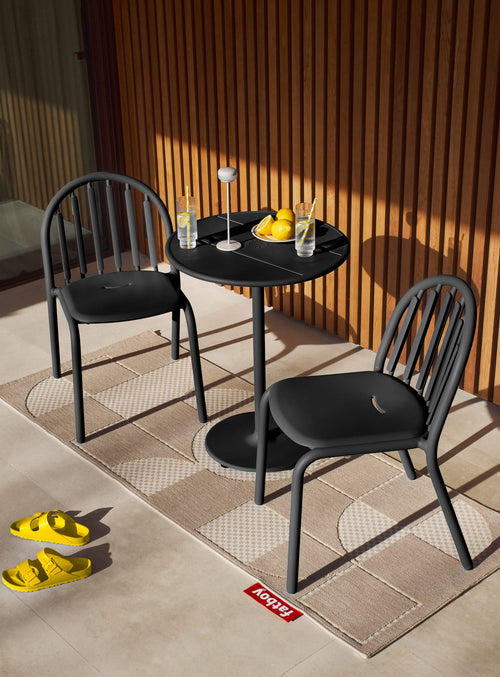 Fred's Bistro Set on a patio featuring a compact table with two chairs in sleek anthracite perfect for stylish outdoor dining spaces.