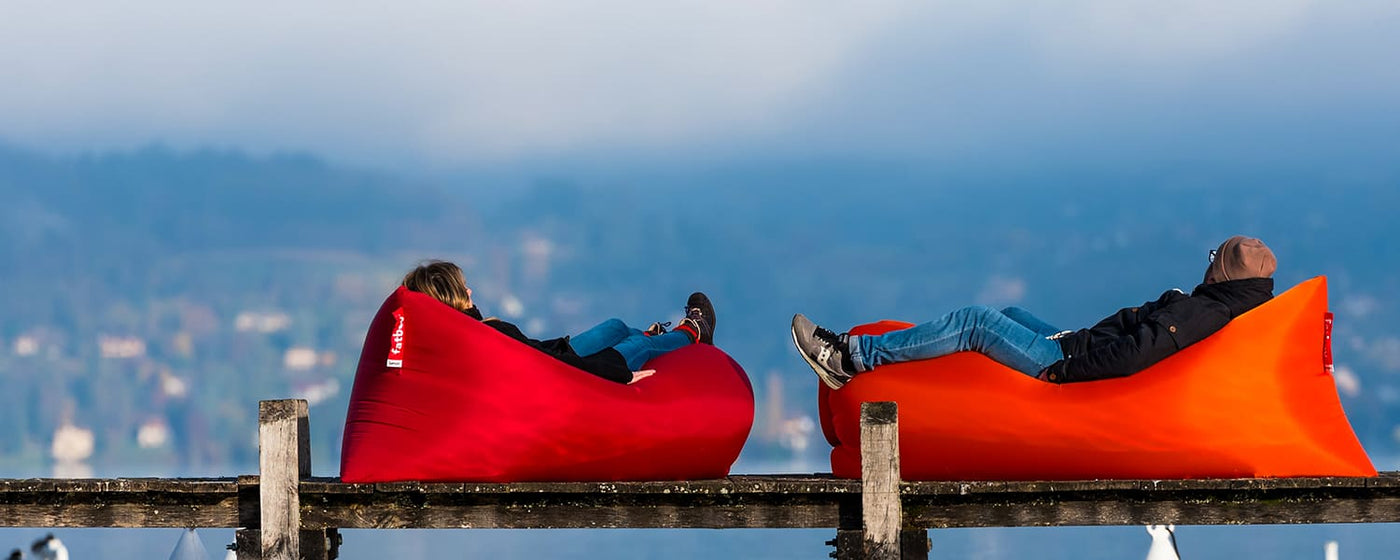 Fatboy Lamzac inflatable lounger in vibrant autumn colors.