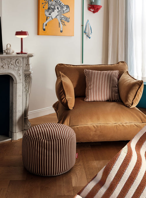 Fatboy Point Terry is a versatile indoor pouf wrapped in striped terry cloth, offering both comfort and style as extra seating or a decorative accent in any room.