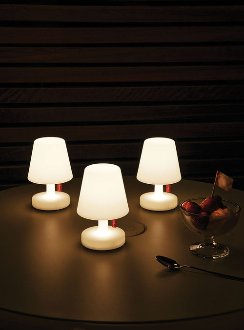 Set of three 'Edison the Mini' table lamps with adjustable brightness, radiating a warm white LED glow suitable for both indoor and outdoor settings.